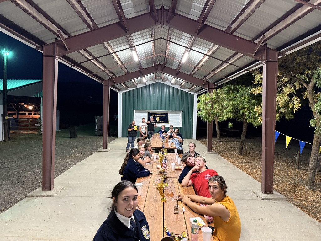 students smile at picnic tables