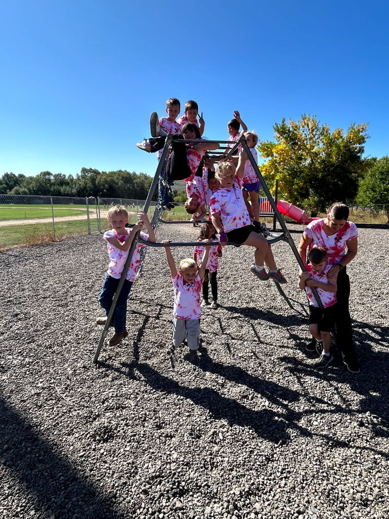 Students pose on jungle gym