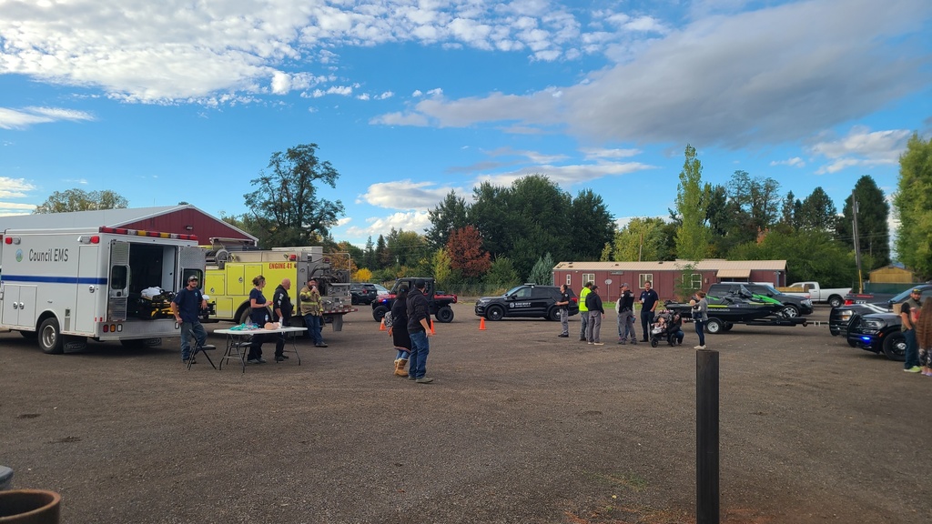 people stand in front of ambulance in parking lot