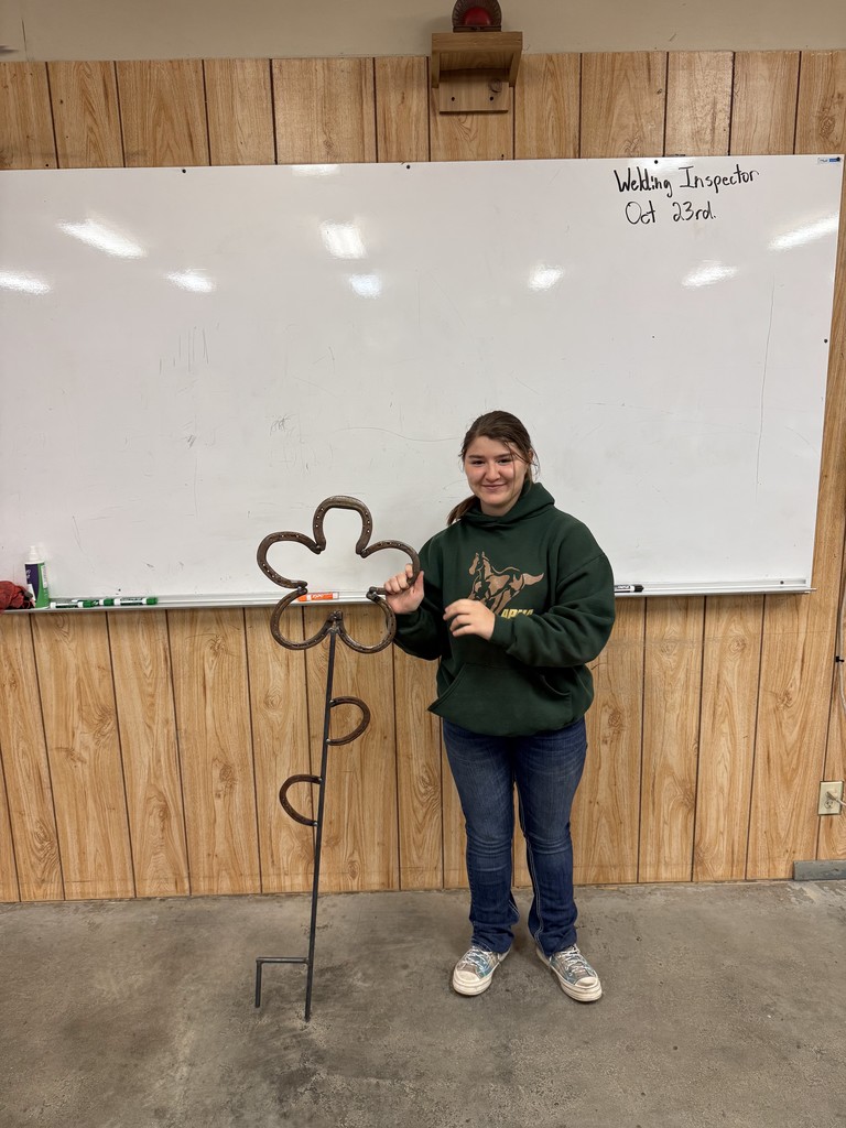 student with horseshoe flower