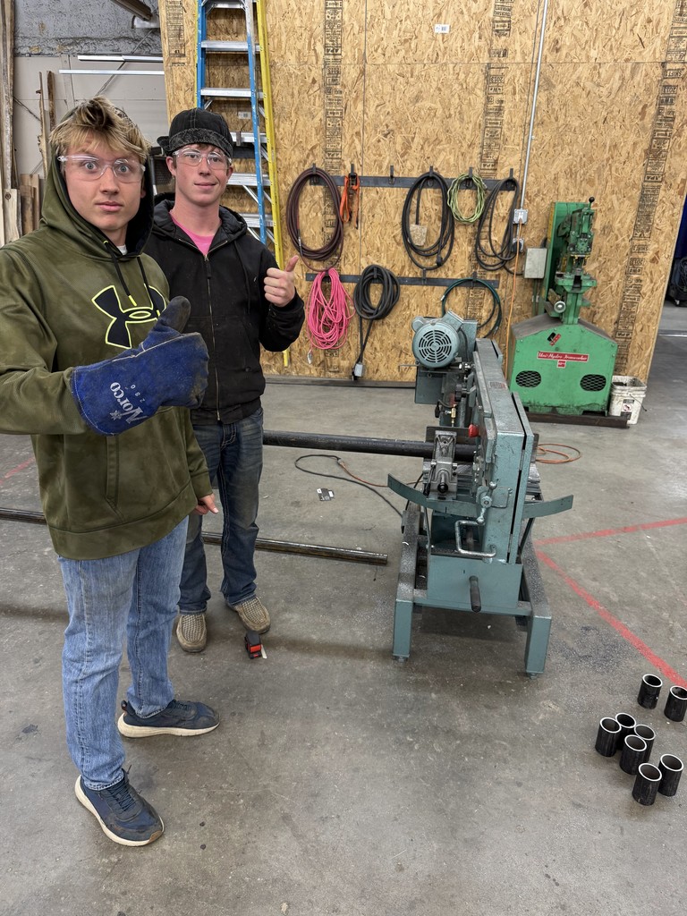 two students give thumbs up