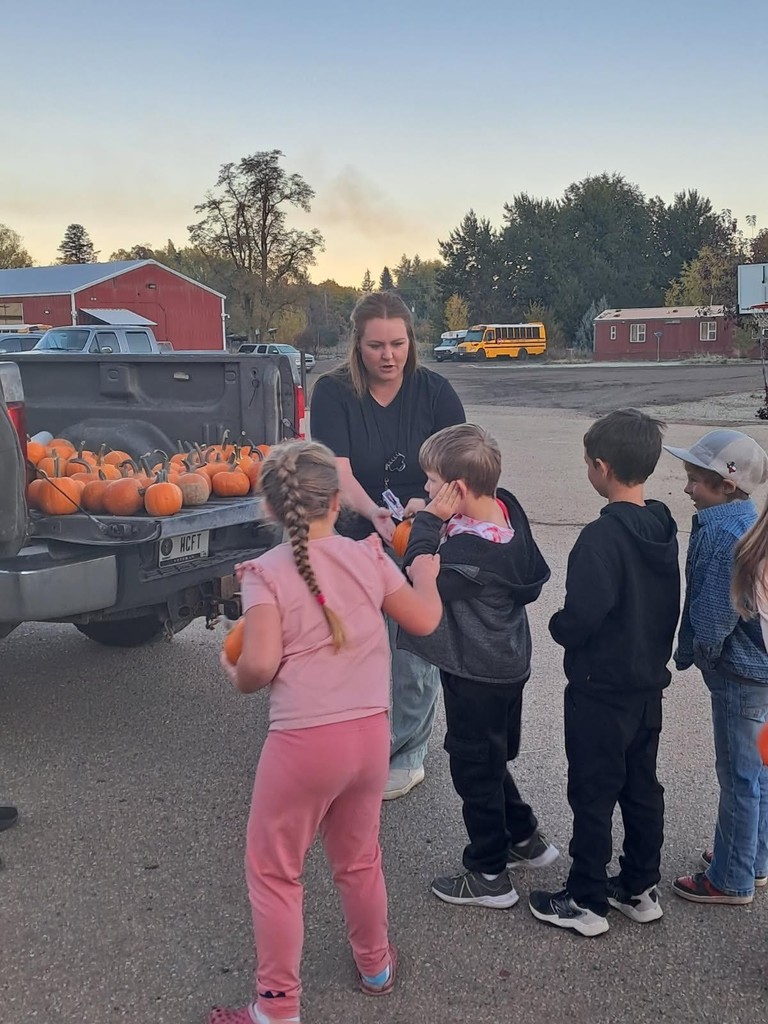 Children wait in line to receive pumpkins