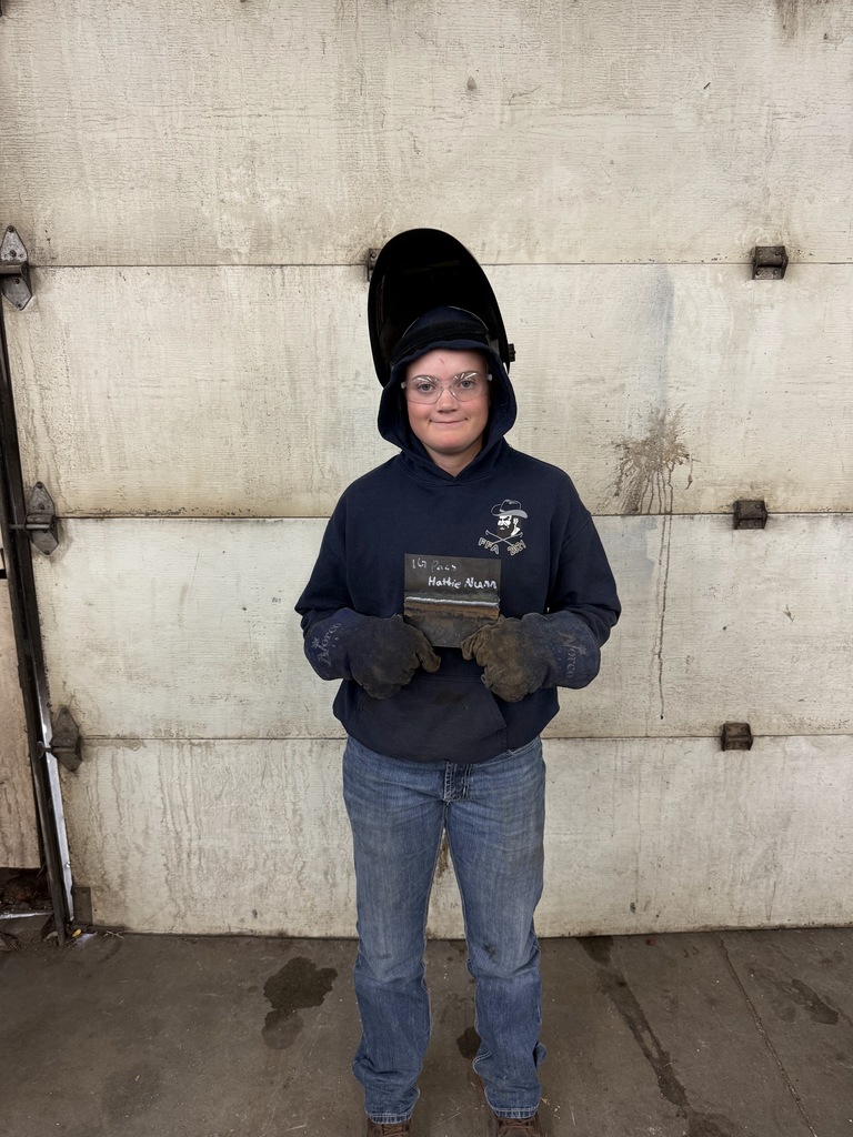 student in welding helmet