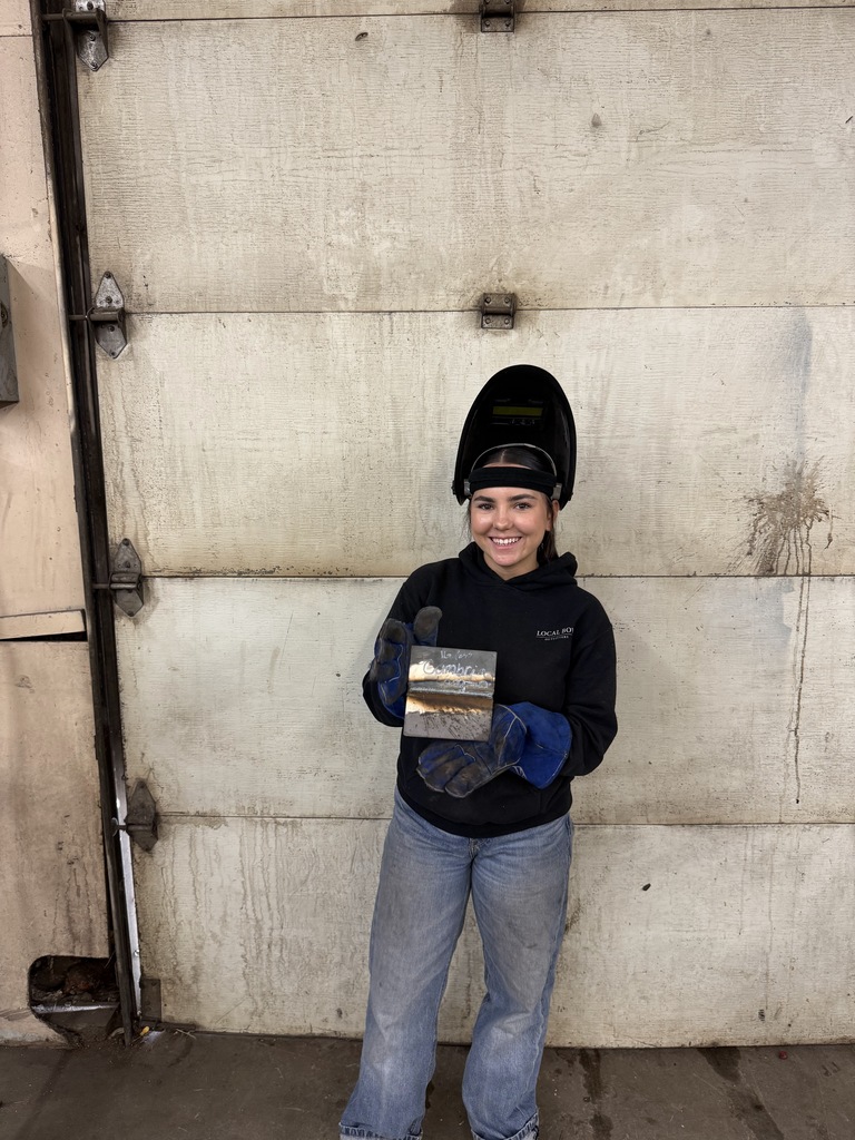 student in welding helmet