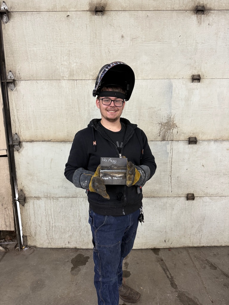 student in welding helmet