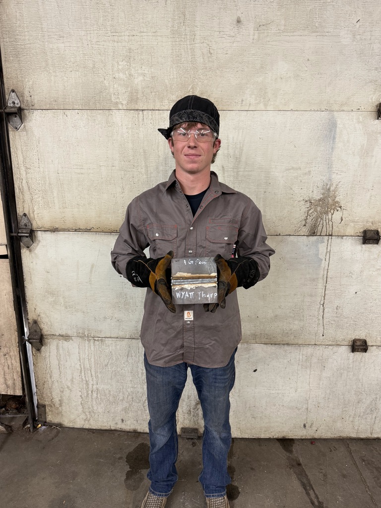 student in welding helmet