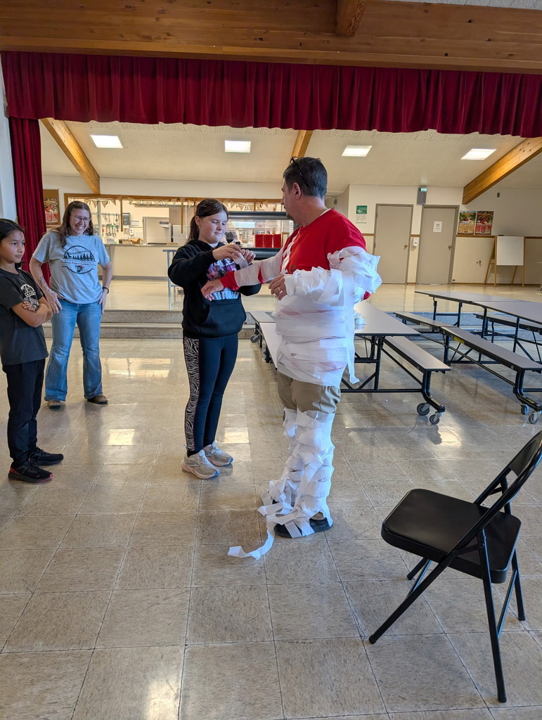 students tie wrap around man
