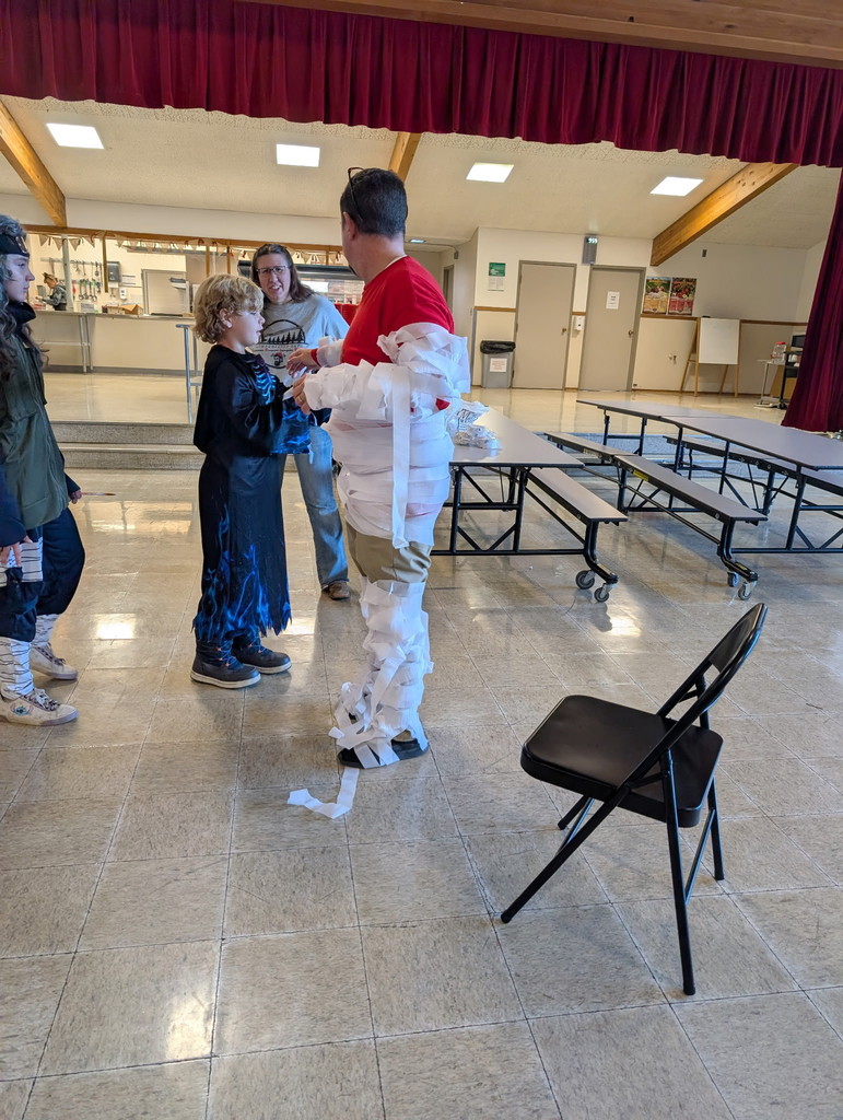 students tie wrap around man