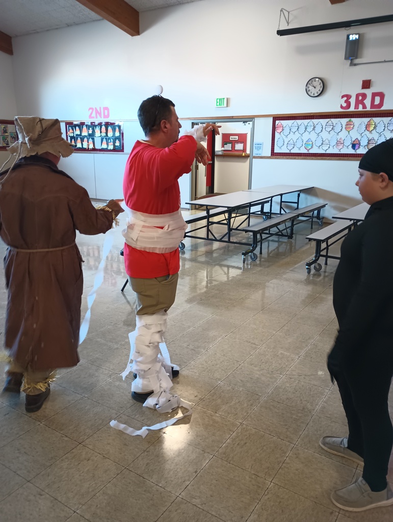 students tie wrap around man