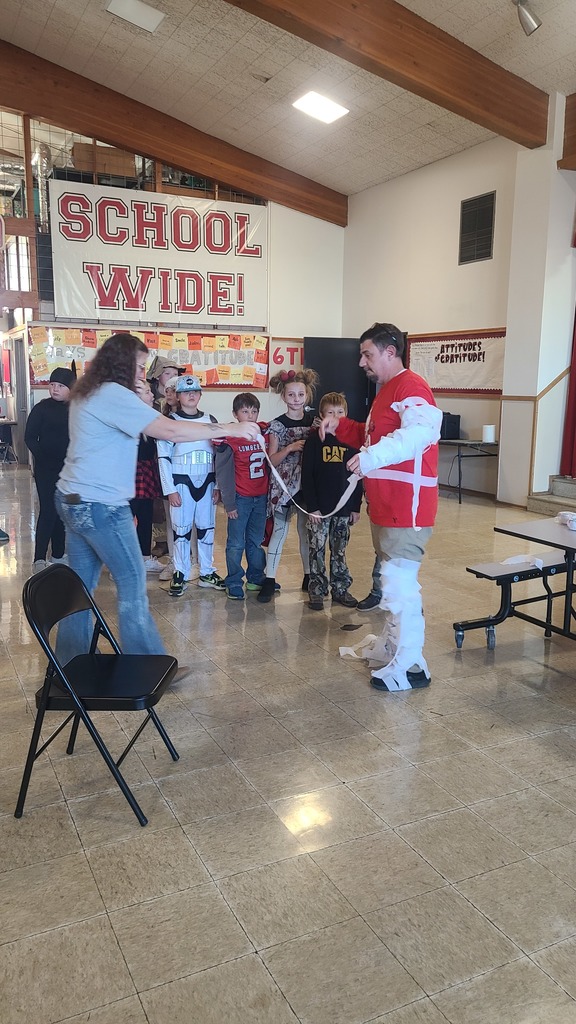 students tie wrap around man