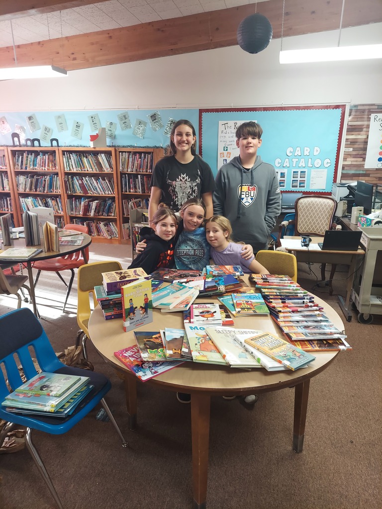 students pose with new books