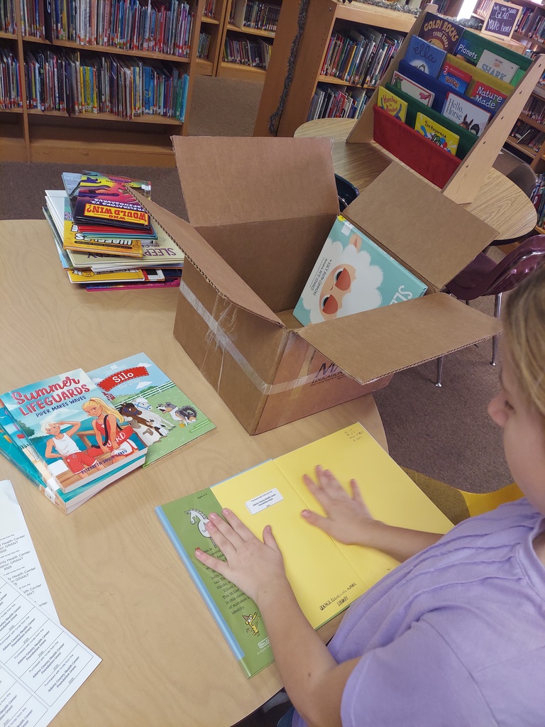 students prepare new books for circulation