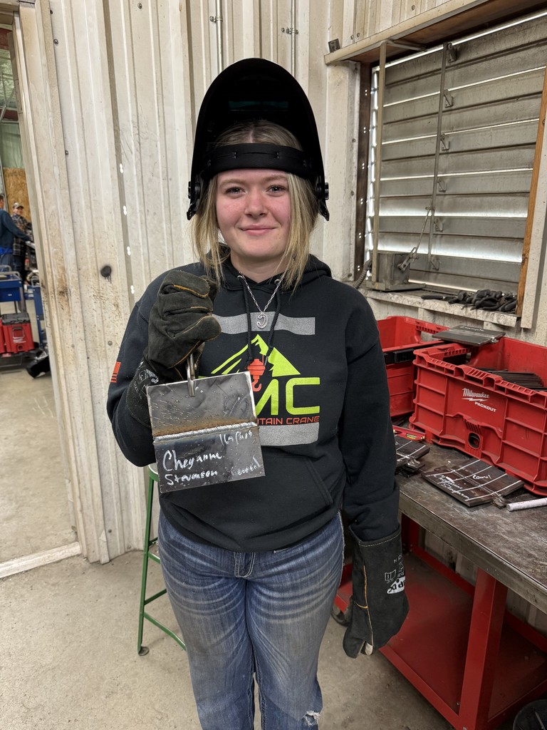 student in welding helment