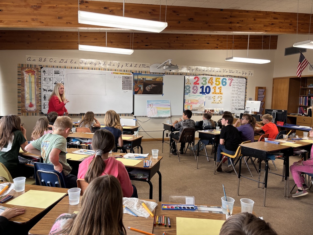 adult in font of classroom of students
