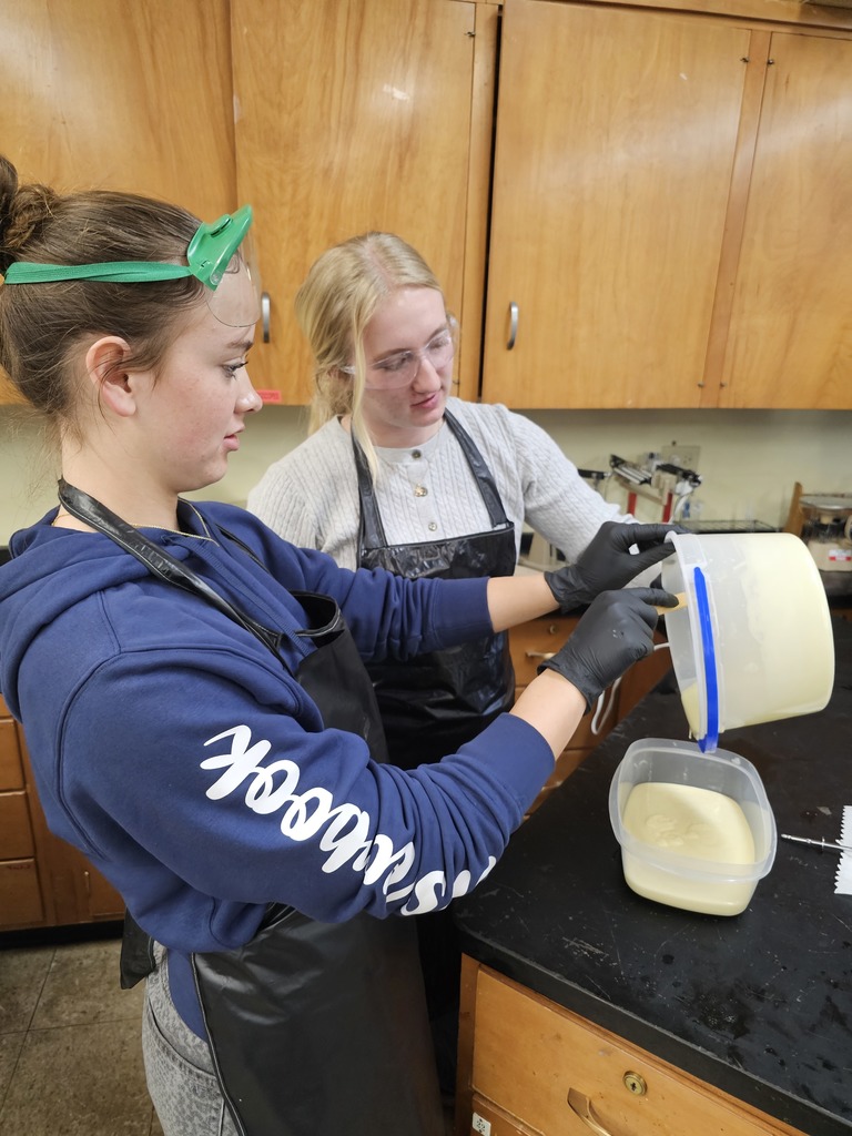 students pour from one container into another
