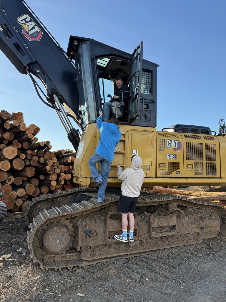 students and logging equipment