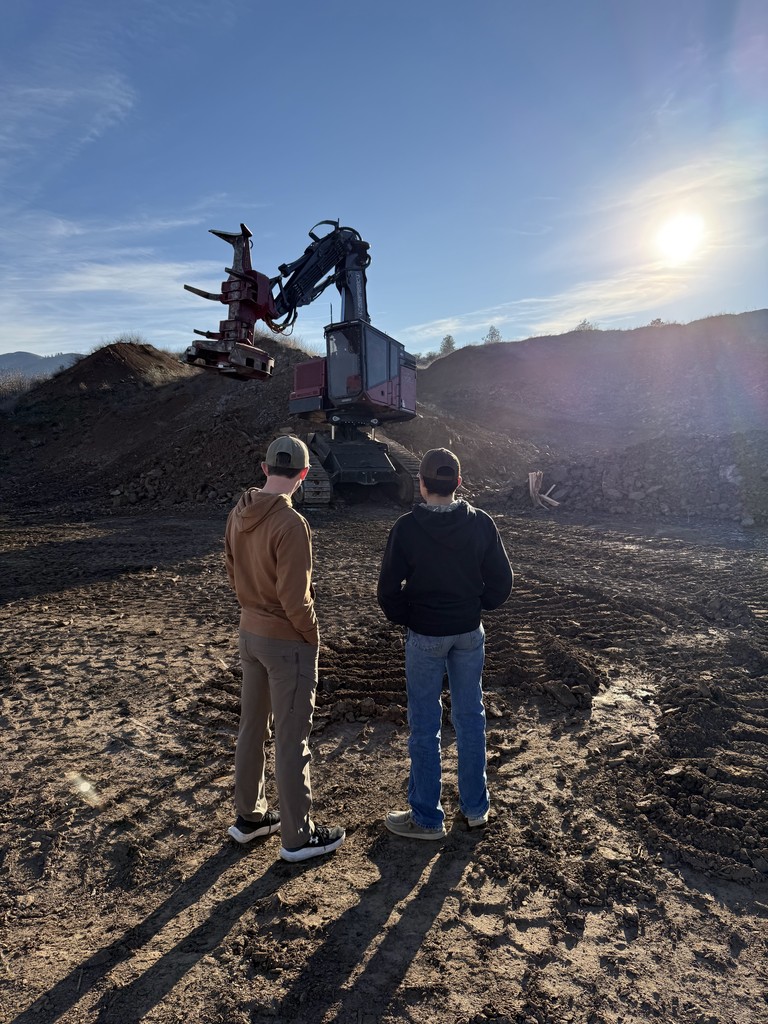 students and logging equipment