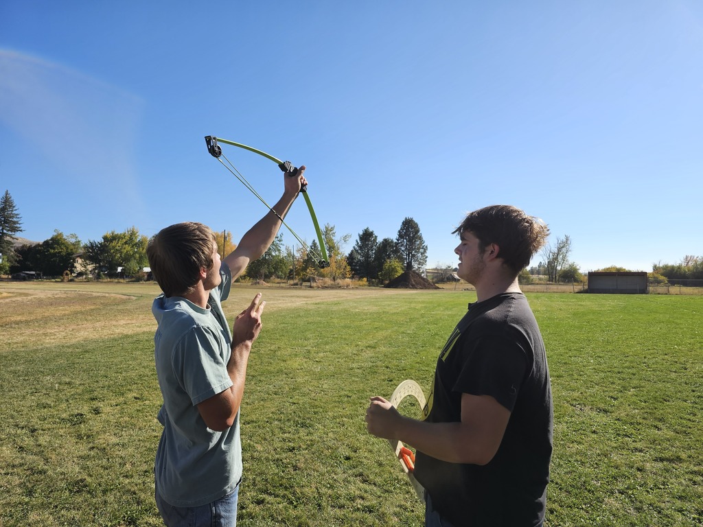 Physics student using bows to learn physics
