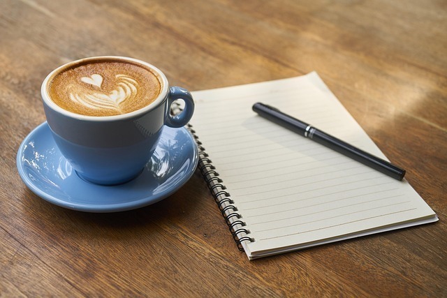 coffee cup with paper and pen