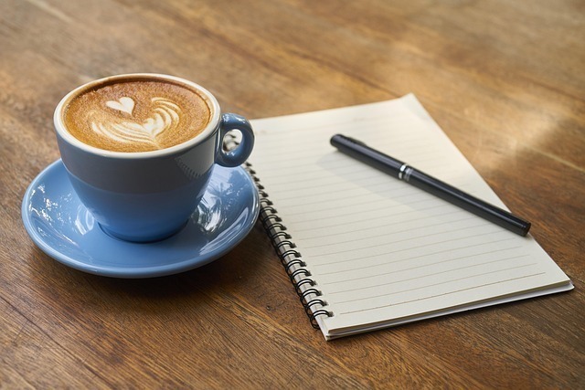 coffee cup with paper and pen