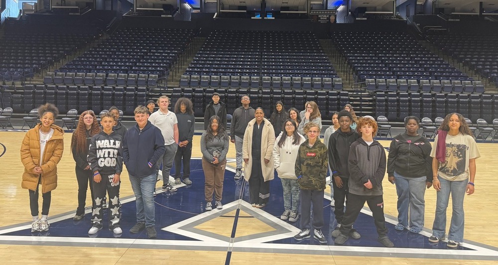 students standing on the X in Cintas Center