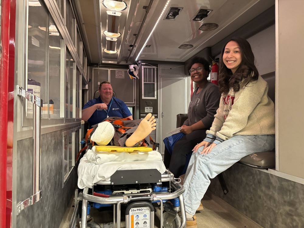 students in the back of an ambulance on a tour