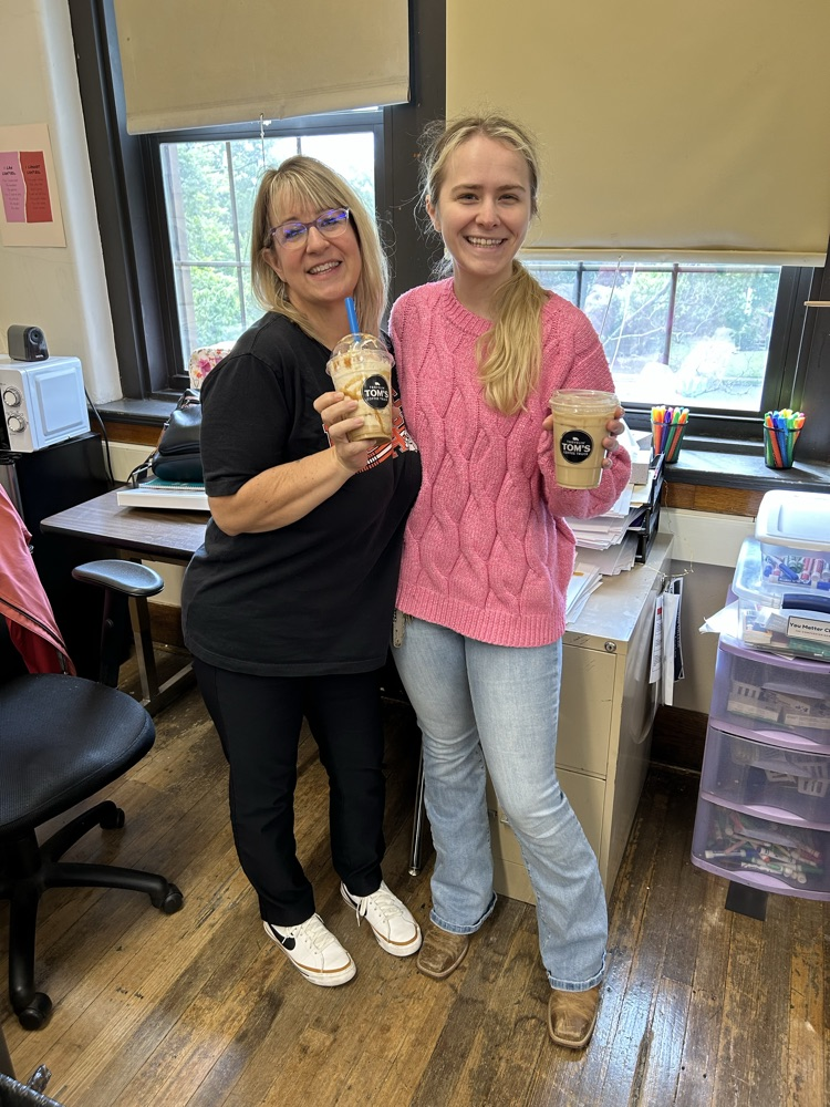 Julie Armstrong and Alexia Davis pose with Travelin’ Tom’s Coffee Truck coffee cups