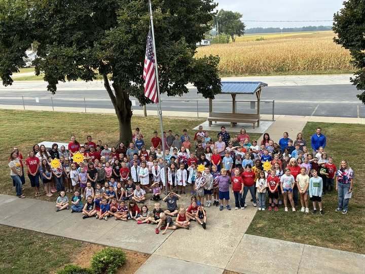 Elementary School Students gathered around the flagpole to honor September 11, 2001