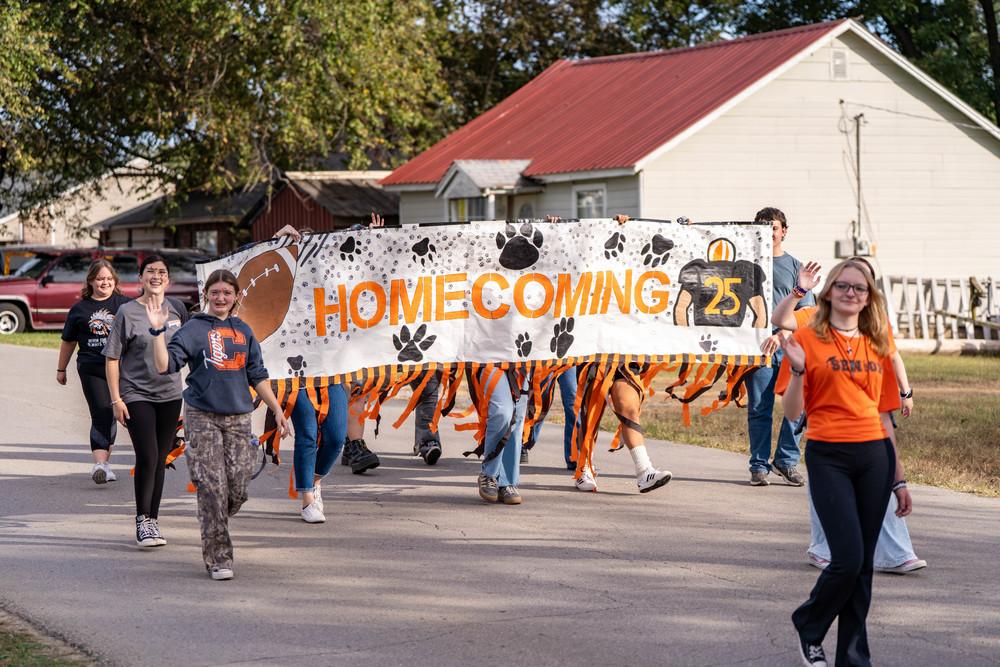 Female students riding on parade float.