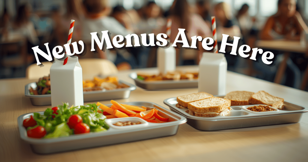 Student lunch room with lunch trays containing heathly food options announcing that New Menus are here.