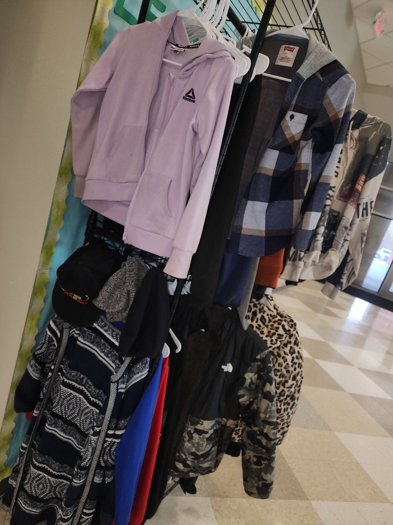 various outerwear on a 2-tiered hanging clothing rack