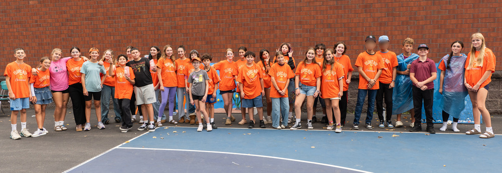 group of students in orange shirts