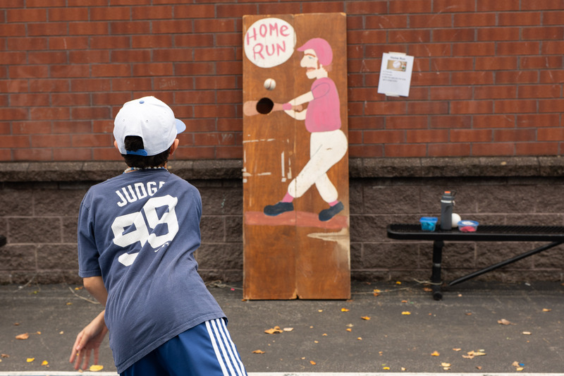 student playing a pitching game