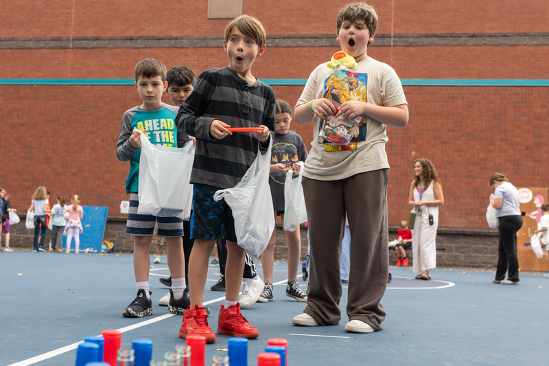 2 students shocked at winning a ring toss game