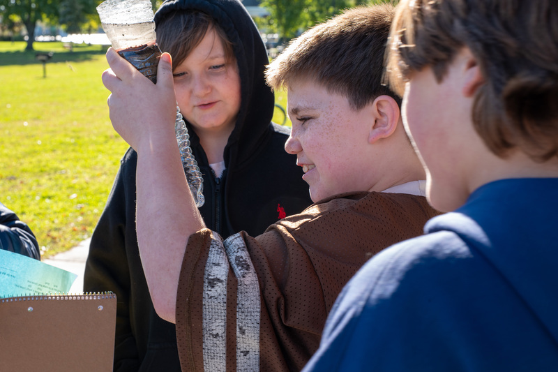 students looking at a water filter