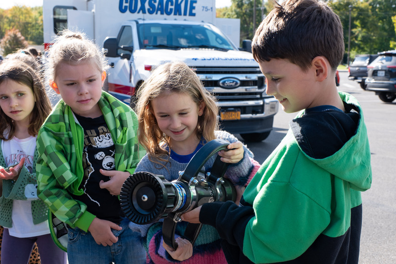 students holding a fire hose head