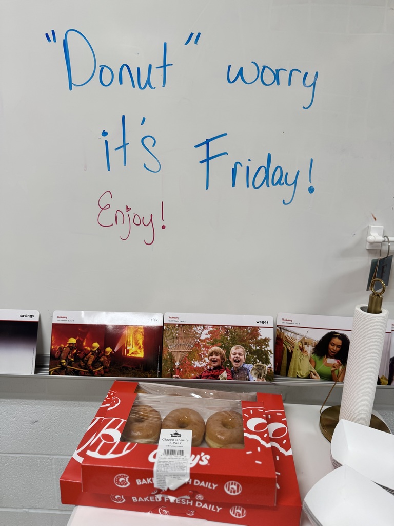 whiteboard with two red boxes of doughnuts in front of it