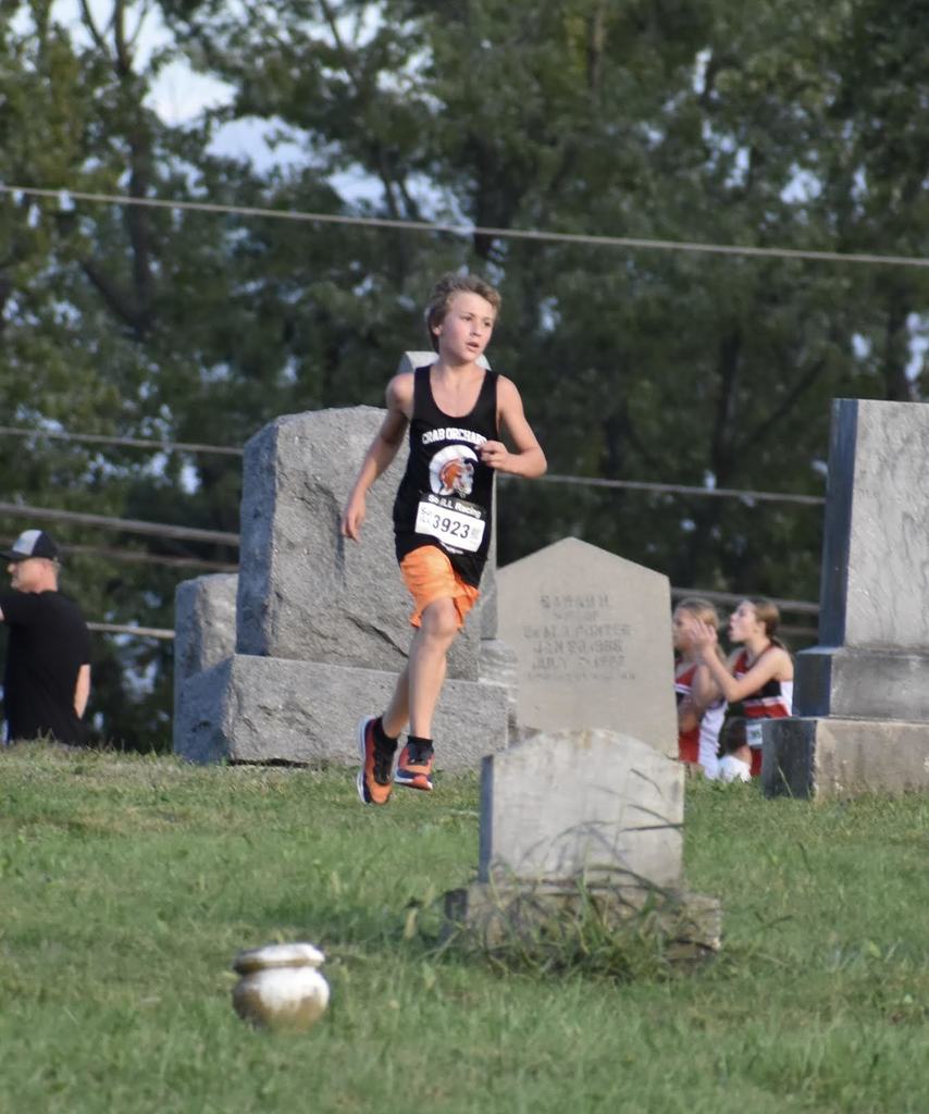 junior high cross country male running in a meet