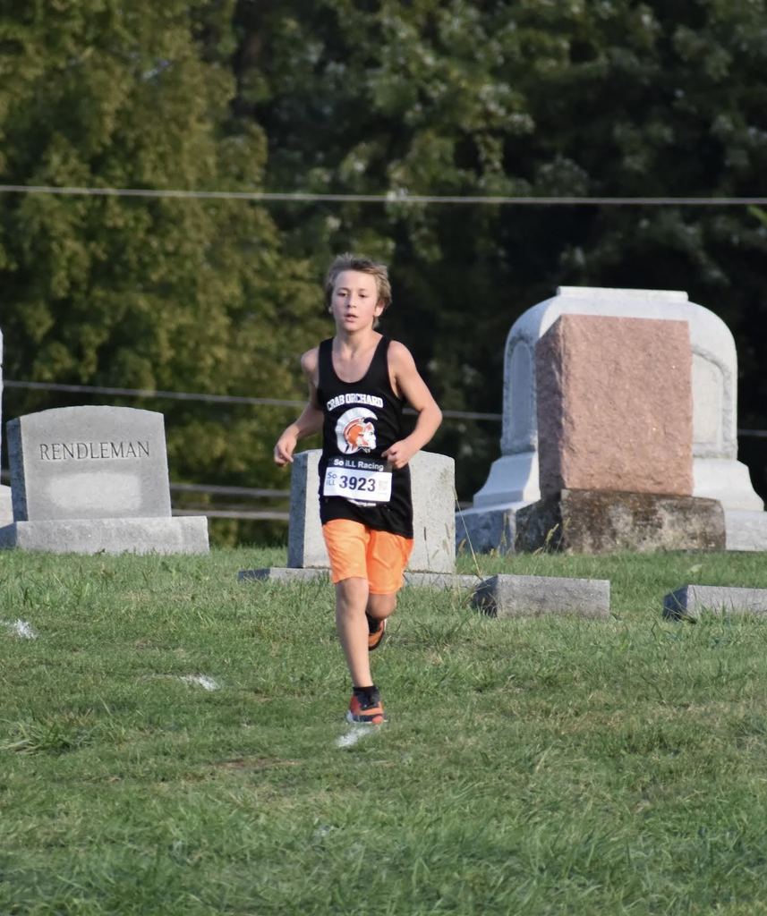 junior high cross country male running in a meet