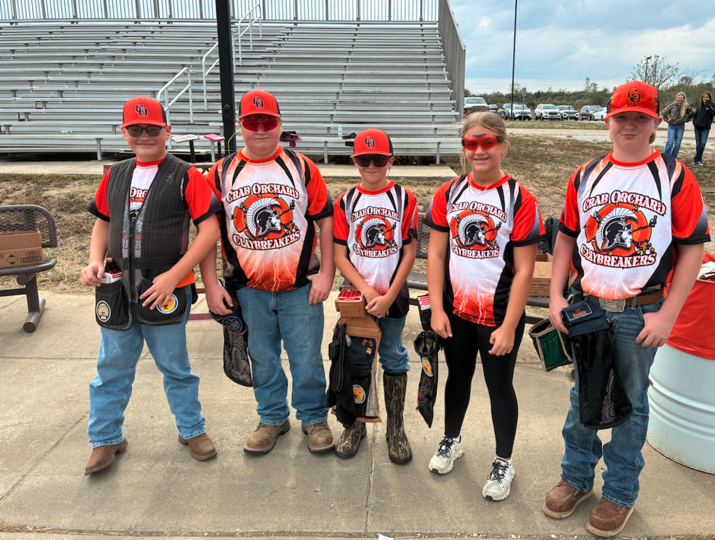 5 junior high claybreaker students standing in front of bleachers