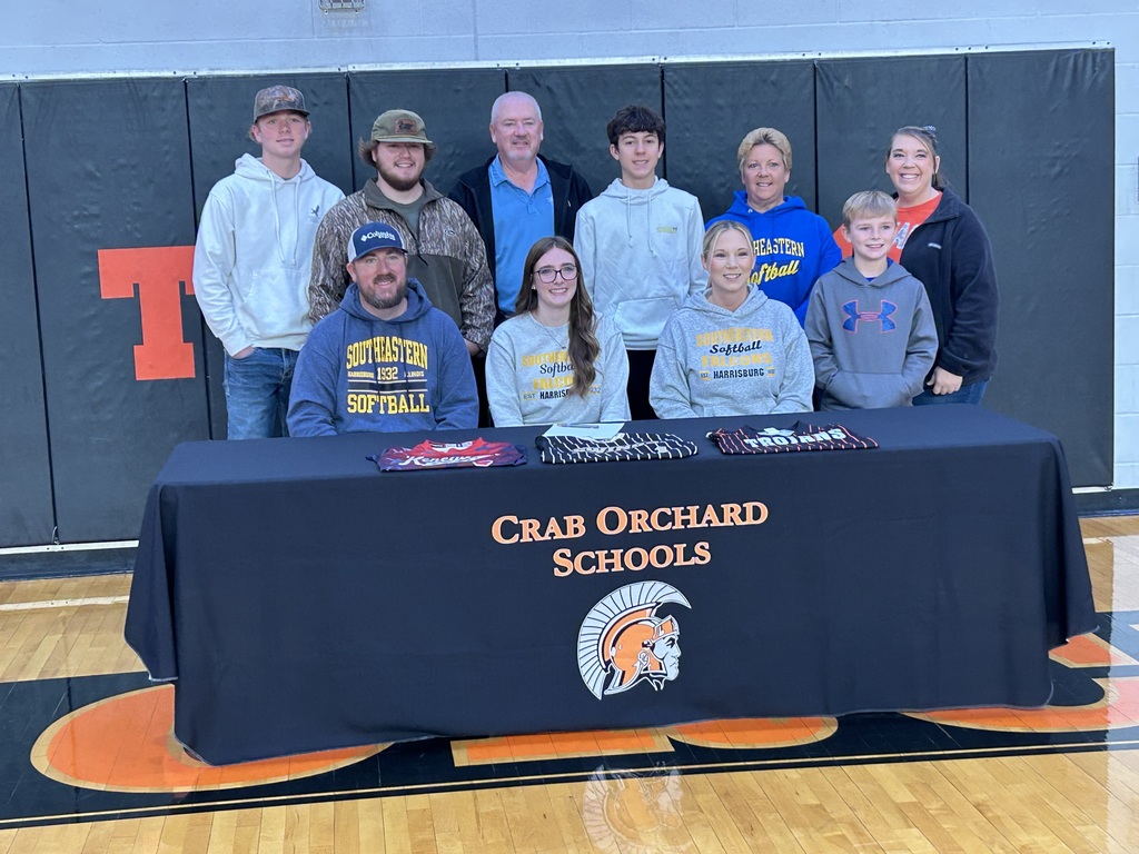 Group of family sitting behind. A table 