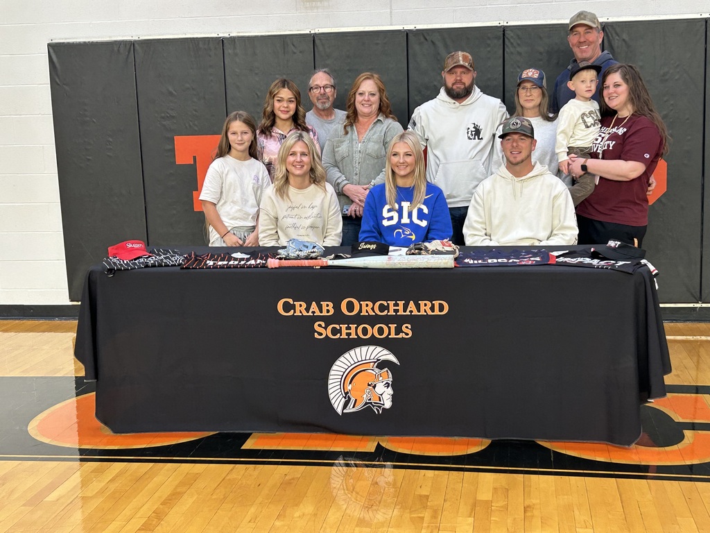 Family behind black table cloth for player signing 