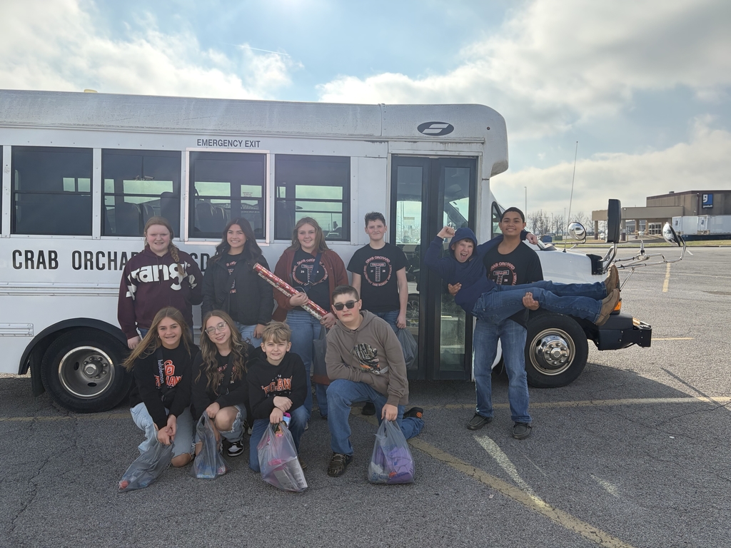 JH Student Council posing in front of small white school bus