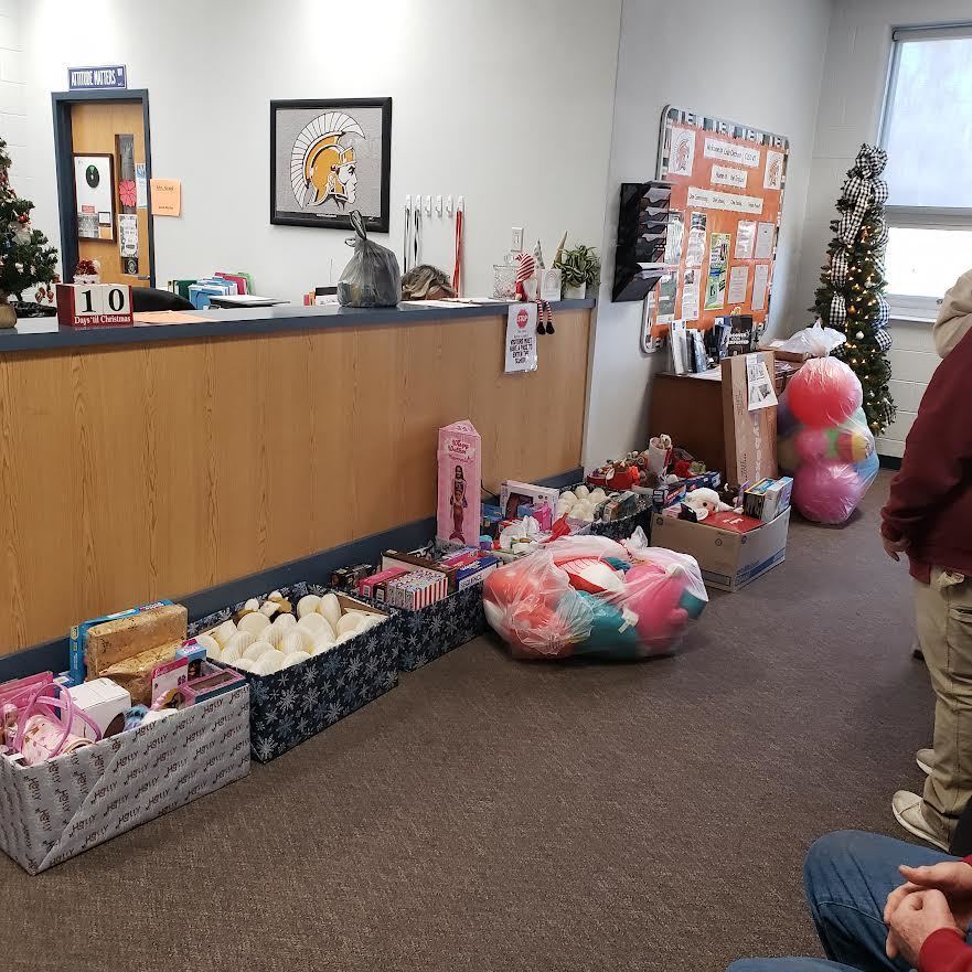 Christmas gifts, in boxes, sitting on the floor of an office