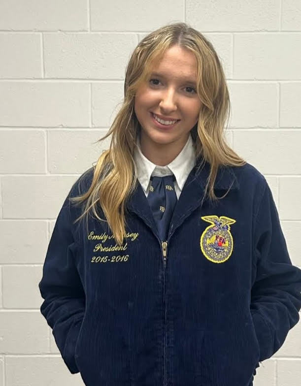 high school student with long blonde hair wearing a dark blue FFA jacket