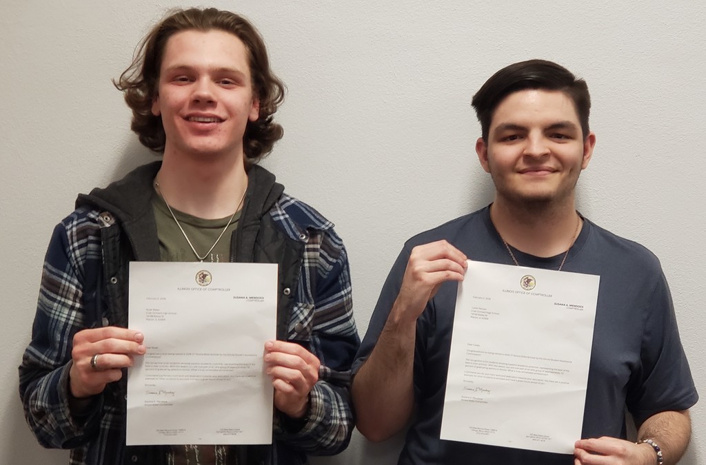 smiling young men holding letters of recognition
