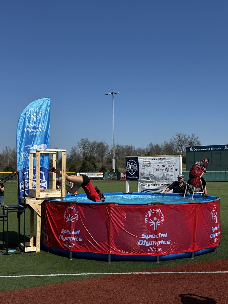 Student in red shirt jumping in pool