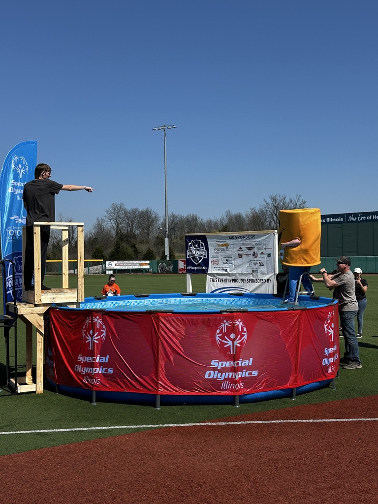 Student in black shirt jumping into pool