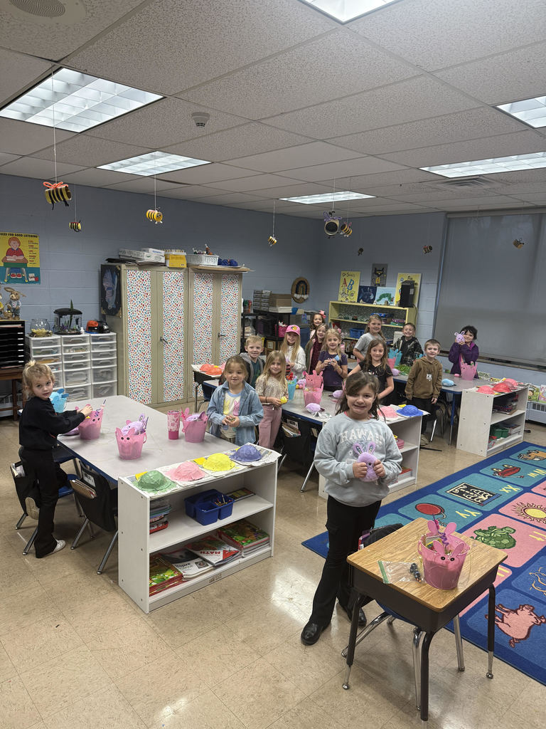 students standing around tables with easter baskets