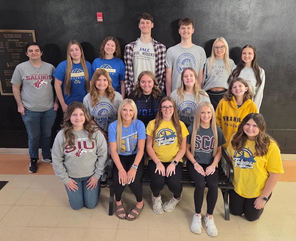 college seniors posing in a hallway with their future college on their shirt